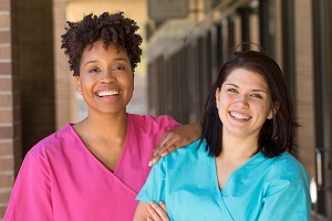 Nurse in Hot Pink Scrub and Nurse in Aqua Scrub Tops