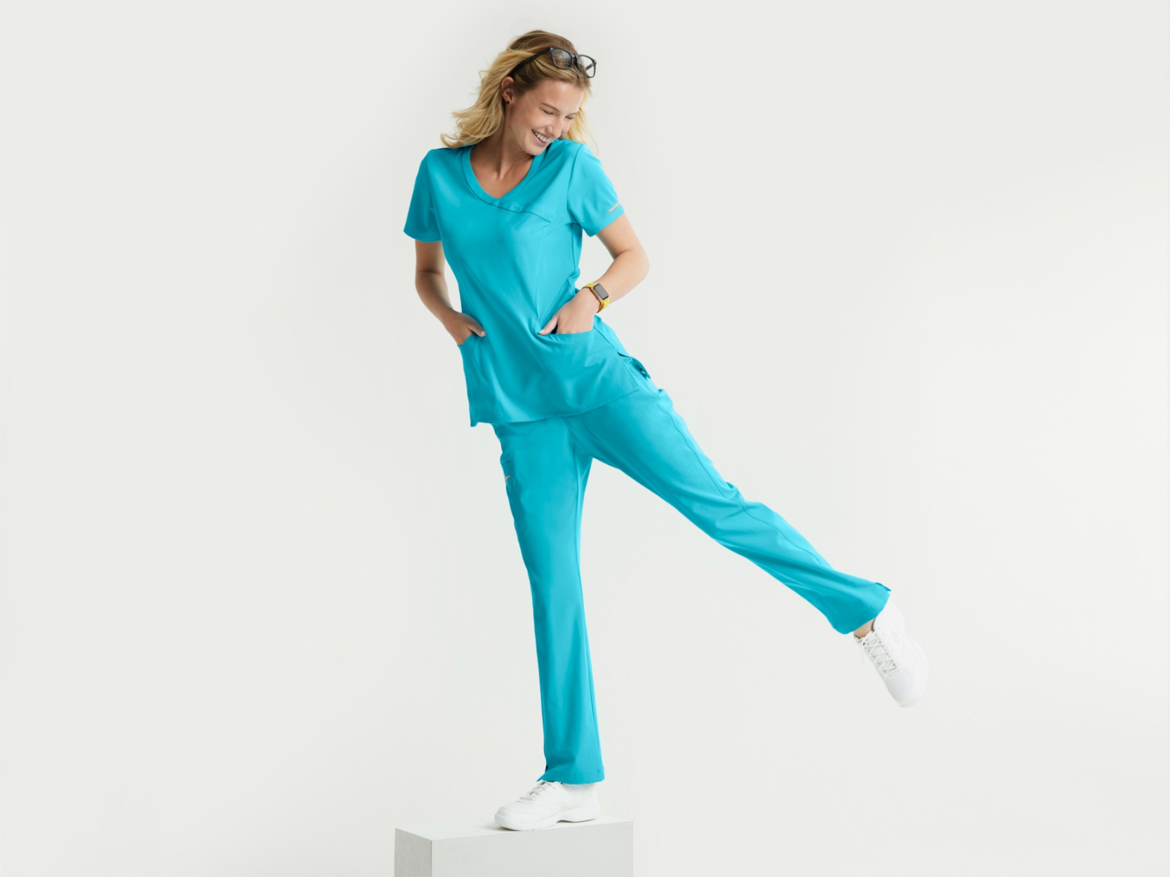 Woman balancing on a box in scrubs